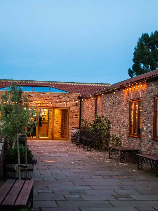 The warmly lit courtyard at Thief Hall