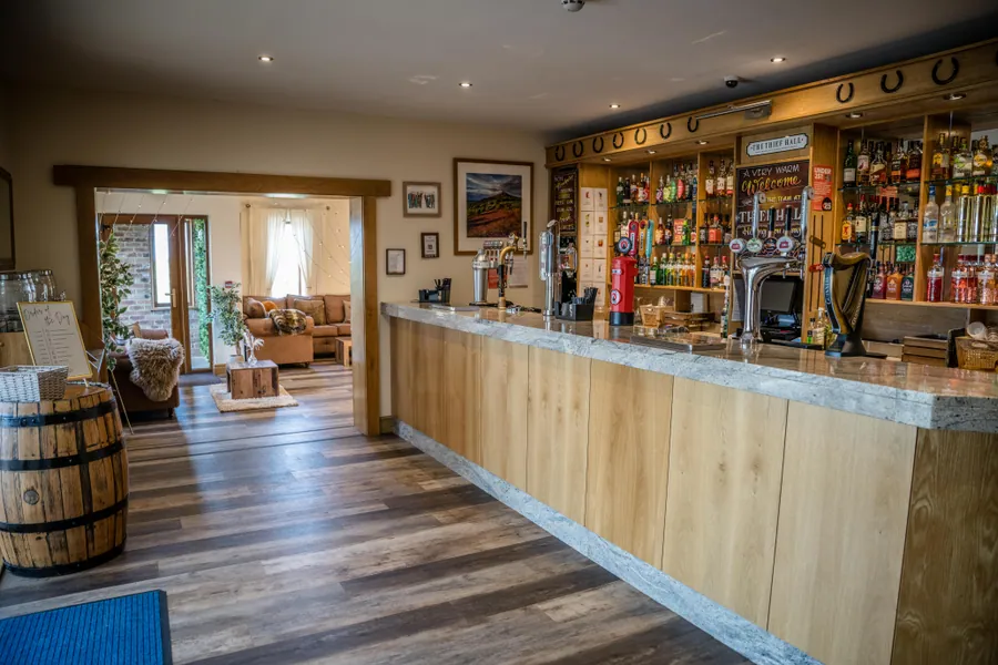 A timber-fronted bar with a lounge visible through the doorway
