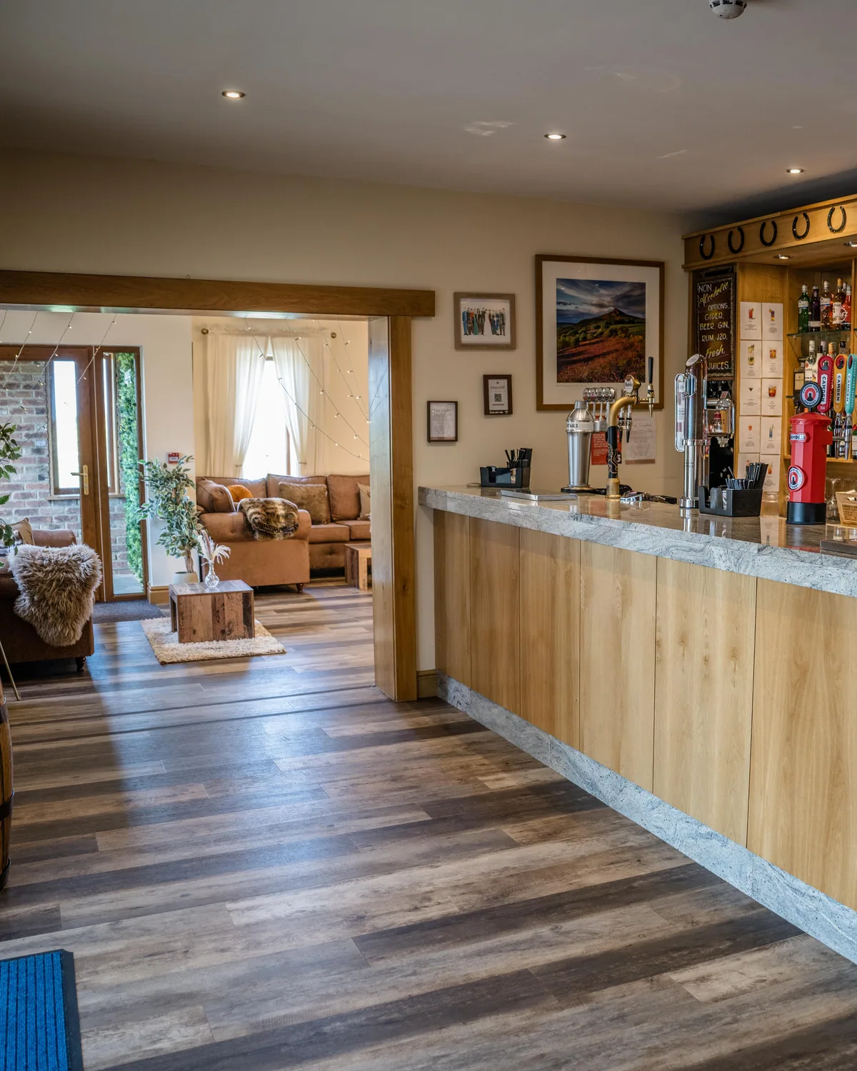 The stocked bar opening through a wide doorway to the lounge beyond
