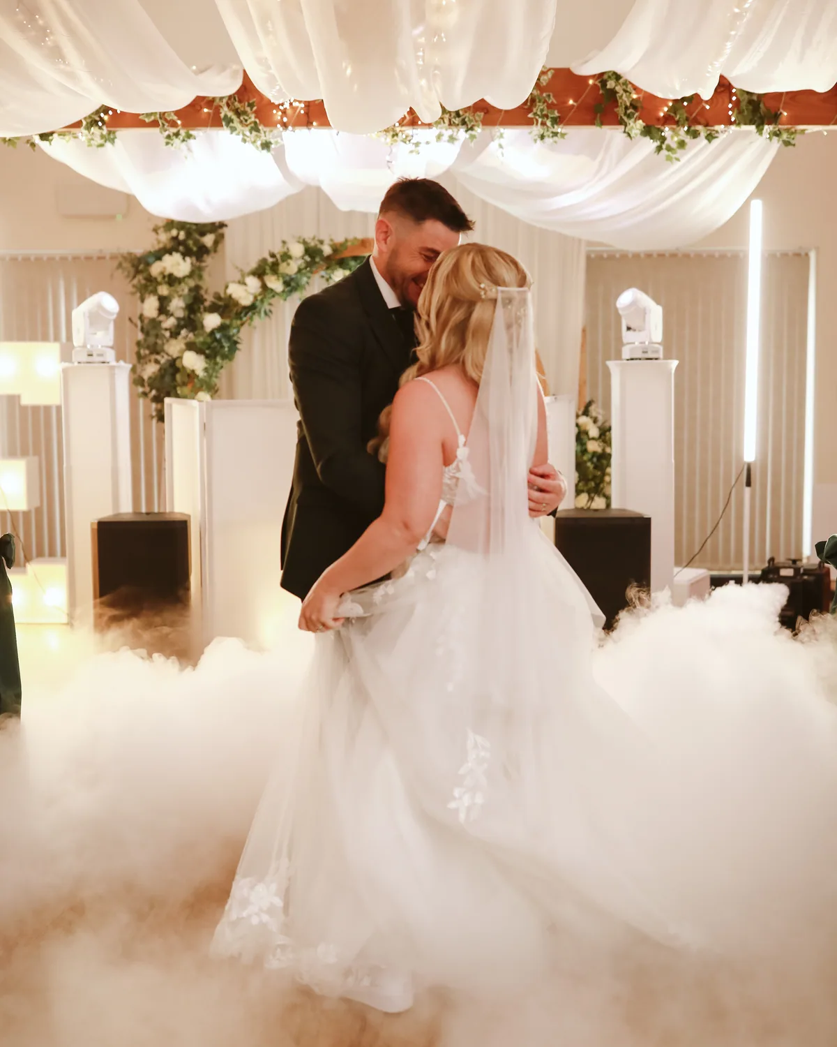 A couple sharing their first dance in low fog